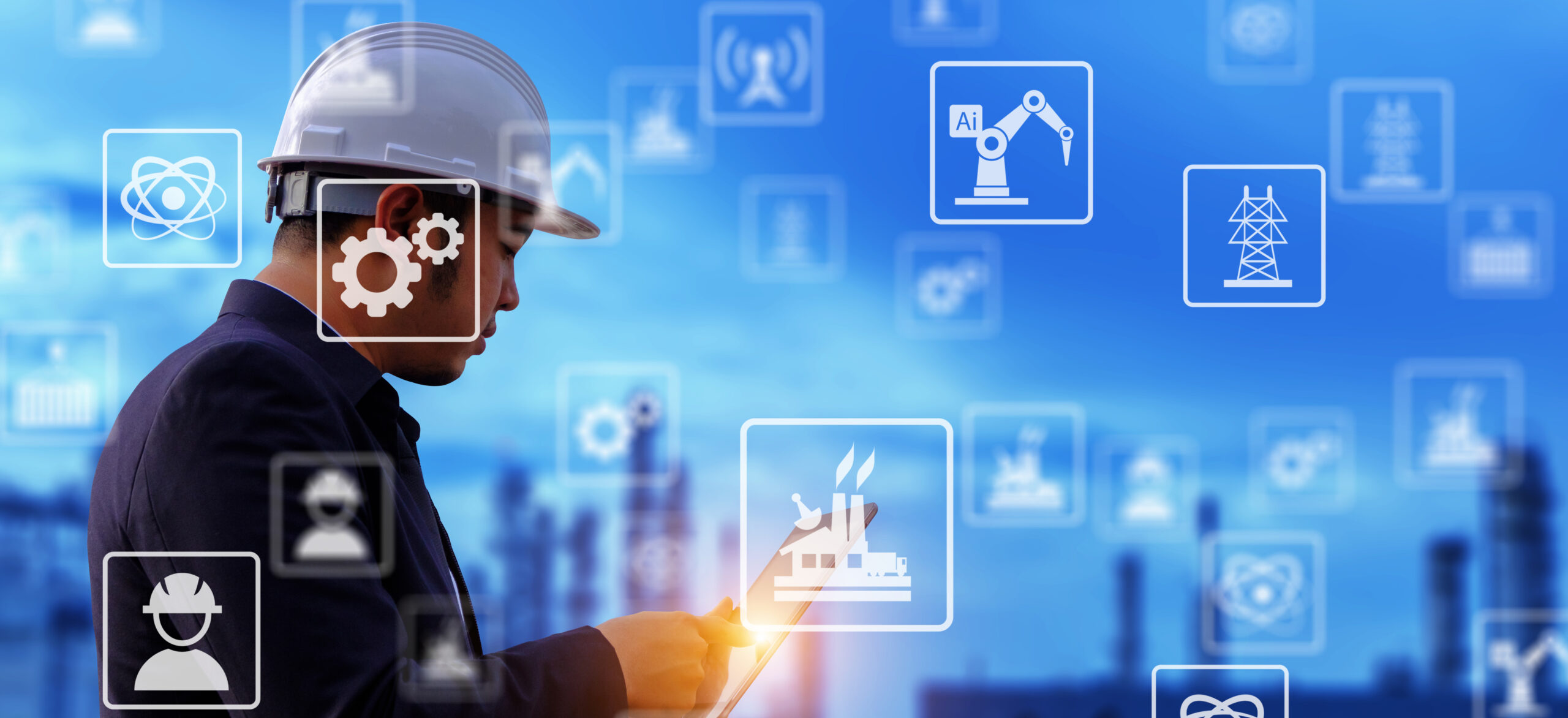 The engineer is working with tabet with large industry background.